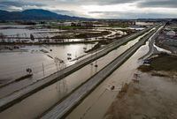 A motorist drives on a service road along the closed Trans-Canada Highway as floodwaters fill the ditches beside the highway and farmland in Abbotsford, B.C., on Wednesday, Dec. 1, 2021. The Senate Committee on Agriculture and Forestry is calling for a comprehensive flood control plan for B.C.'s Fraser Valley following last year's historic floods. THE CANADIAN PRESS/Darryl Dyck