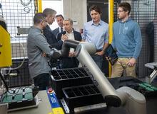 Prime Minister Justin Trudeau looks at a robotic arm during a visit to FLO, a maker of electric car chargers,  in Shawinigan, Que., Wednesday, January 18, 2023. THE CANADIAN PRESS/Ryan Remiorz