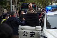 In this photo taken on Sunday, Nov. 27, 2022, a protester reacts as he is arrested by policemen during a protest on a street in Shanghai, China. Authorities eased anti-virus rules in scattered areas but affirmed China's severe "zero- COVID" strategy Monday after crowds demanded President Xi Jinping resign during protests against controls that confine millions of people to their homes. (AP Photo)