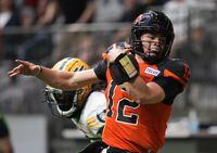 B.C. Lions quarterback Nathan Rourke (12) is pushed out of bounds by Edmonton Elks' Jalen Collins as he runs with the ball during the first half of CFL football game in Vancouver, on Saturday, June 11, 2022. THE CANADIAN PRESS/Darryl Dyck