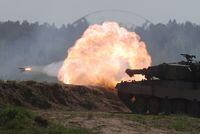 FILE PHOTO: A Polish Leopard 2PL tank fires during Defender Europe 2022 military exercise of NATO troops including French, American, and Polish troops, amid the Russian invasion of Ukraine, at the military range in Bemowo Piskie, near Orzysz, Poland May 24, 2022. REUTERS/Kacper Pempel/File Photo