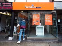 Rogers Communications Inc., Shaw Communications Inc. and Quebecor Inc. have entered a definitive agreement for the sale of wireless carrier Freedom Mobile. A man enters  Freedom Mobile  store in Toronto on Thursday, November 24, 2016.  THE CANADIAN PRESS/Nathan Denette