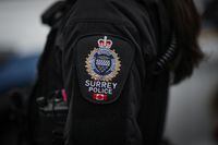 A Surrey police patch is seen on an officer's jacket in Surrey, B.C., on Saturday, April 22, 2023. The police force says delays deciding the future of policing in the city are weighing heavily on officers. THE CANADIAN PRESS/Darryl Dyck