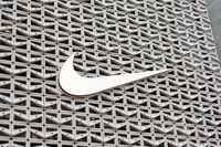 MIAMI BEACH, FLORIDA - DECEMBER 21: The Nike logo hangs above the entrance to the Nike store on December 21, 2021 in Miami Beach, Florida. Nike reported better-than-expected fiscal second-quarter results with revenue of $11.36 billion vs. $11.25 billion expected. (Photo by Joe Raedle/Getty Images)