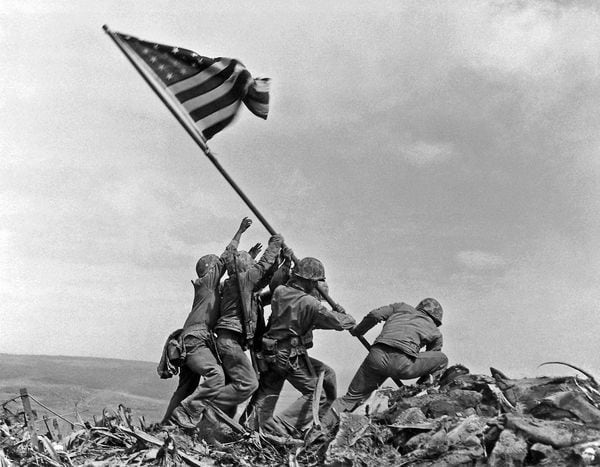 U.S. Marines of the 28th Regiment of the Fifth Division raise the American flag atop Mt. Suribachi, Iwo Jima, in this Feb. 23, 1945 file photo. When aging patriots gather to mark the dedication of the National World War II Memorial next spring in Washington, they will encounter the sights and sounds from the era of the generation's greatest accomplishments. More than 100 Associated Press photographs, including Joe Rosenthal's iconic Pulitzer Prize-winning photo of Marines raising the flag on Iwo Jima, will be displayed at historic Union Station.  (AP Photo/Joe Rosenthal/FILE)