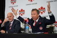 Canada Soccer president Nick Bontis, right, speaks as interim general secretary Earl Cochrane listens during a news conference, in Vancouver, on Sunday, June 5, 2022. After refusing to train on Friday and Saturday, Canada's men's soccer team said it refused to play its World Cup warmup match against Panama Sunday because of a labour dispute with Soccer Canada. THE CANADIAN PRESS/Darryl Dyck