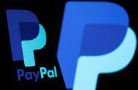 FILE PHOTO: The PayPal logo is seen on a smartphone in front of the same logo displayed in this illustration taken September 8, 2021. REUTERS/Dado Ruvic/Illustration/File Photo