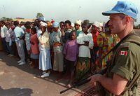 A Canadian peacekeeper watches a group of Rwandan refugees in Kigali, Rwanda, in this August 1994 photo. THE CANADIAN PRESS/Ryan Remiorz