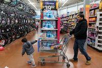 FILE PHOTO: A boy and his father walk through the toy section of Walmart on Black Friday, a day that kicks off the holiday shopping season, in King of Prussia, Pennsylvania, U.S., on November 29, 2019. REUTERS/Sarah Silbiger./File Photo