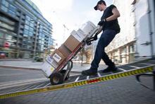 A worker making a food supply delivery to a downtown Toronto restaurant is photographed on Nov 10, 2022. Fred Lum/The Globe and Mail. 