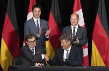 Canadian Prime Minister Justin Trudeau and German Chancellor Olaf Scholz applaud as Natural Resources Minister Jonathan Wilkinson and German vice-chancellor Robert Habeck shake hands after signing an agreement&nbsp;in Stephenville, N.L., Tuesday, Aug. 23, 2022. Wilkinson says he expects to know the final investment decisions on at least two new hydrogen production projects in Atlantic Canada before the end of the year. THE CANADIAN PRESS/Adrian Wyld