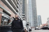 Real estate investor Sahil Jaggi poses for a portrait in front of condominium buildings at 2200 Lakeshore Boulevard West in Etobicoke, ON on April 21st, 2023. Duane Cole/The Globe and Mail