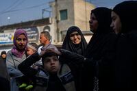 A family heads to the al-Kadhimayn shrine in Baghdad, Iraq, on Saturday, Feb. 25, 2023. For Iraqis, the war and U.S. occupation which started two decades ago were traumatic – an estimated 300,000 Iraqis were killed between 2003 and 2019, according to an estimate by the Watson Institute for International and Public Affairs at Brown University, in addition to some 4,000 Americans. (AP Photo/Jerome Delay)