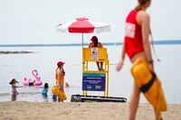 Lifeguards work at Brittany Beach of the Ottawa River in Ottawa on Friday, June 24, 2022. Municipalities across Canada are grappling with lifeguard shortages as city pools and beaches open for the summer. THE CANADIAN PRESS/Sean Kilpatrick