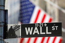 FILE PHOTO: A street sign for Wall Street is seen outside the New York Stock Exchange (NYSE) in New York City, New York, U.S., July 19, 2021. REUTERS/Andrew Kelly/File Photo