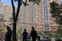 Russian law enforcement officers stand guard near a damaged multi-storey apartment block following a reported drone attack in Moscow, Russia, May 30, 2023. REUTERS/Evgenia Novozhenina