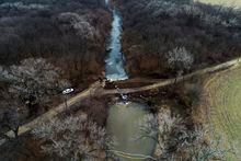 FILE - In this photo taken by a drone, cleanup continues in the area where the ruptured Keystone pipeline dumped oil into a creek in Washington County, Kan., Dec. 9, 2022. The Environmental Protection Agency announced Monday, Jan., 9, 2023, that it has reached an agreement with a pipeline operator to clean up a spill that dumped 14,000 bathtubs’ worth of crude oil into a rural Kansas creek. (DroneBase via AP, File)