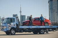 Dan Park (left), CEO of Clutch, a Canadian startup that is an online marketplace for buying cars, is photographed with Stephen Seibel, COO and Founder, with their delivery flat-bed truck, in Toronto, on Fri., March, 19, 2021. (Christopher Katsarov/The Globe and Mail)