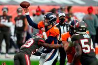 Denver Broncos quarterback Brett Rypien is hit by Tampa Bay Buccaneers free safety Jordan Whitehead as he throws a pass on Sept. 27, 2020, in Denver. Rypien will start against the New York Jets on Thursday Night Football.