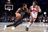 Oct 21, 2022; Brooklyn, New York, USA;  Brooklyn Nets guard Kyrie Irving (11) drives on Toronto Raptors forward O.G. Anunoby (3) during the fourth quarter at Barclays Center. Mandatory Credit: Dennis Schneidler-USA TODAY Sports