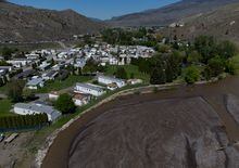 The swollen Bonaparte River flows past an evacuated mobile home community in Cache Creek, B.C., on Sunday, May 14, 2023. A flood warning has been issued for the Skeena region of northwestern British Columbia as unseasonably warm temperatures swell rivers in many areas of the province. THE CANADIAN PRESS/Darryl Dyck
