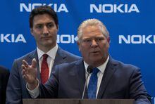 Prime Minister Justin Trudeau looks on as Ontario Premier Doug Ford responds to a question following an announcement in Ottawa, Monday, Oct. 17, 2022.&nbsp;Ford says he supports the measures taken by the federal government to end the so-called "Freedom Convoy" protests last winter. THE CANADIAN PRESS/Adrian Wyld