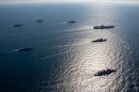 FILE - U.S. aircraft carrier USS Ronald Reagan, top right, participates with other U.S. and South Korean navy ships during the joint naval exercises between the United States and South Korea in waters off South Korea's eastern coast in South Korea, on Sept. 29, 2022. South Korea, U.S. and Japanese warships launched their first anti-submarine drills in five years on Friday, Sept. 30, after North renewed ballistic missile tests this week in an apparent response to bilateral training by South Korean and U.S. forces.(South Korea Navy/Yonhap via AP, File)