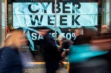 Shoppers walk past a store advertising a so-called "Cyber Week" sale, in Berlin on November 23, 2018. - "Cyber Monday" marks the Monday after the Thanksgiving holiday in the United States, created by marketing companies to encourage people to shop online. (Photo by John MACDOUGALL / AFP)JOHN MACDOUGALL/AFP/Getty Images
