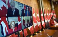 Minister of International Trade Mary Ng watches pre-recorded footage from an earlier video conference that she participated in with Prime Minister Justin Trudeau, British Prime Minister Boris Johnson and International Trade Secretary Liz Truss, during a news conference on the Canada-United Kingdom Trade Continuity Agreement in Ottawa, on Nov. 21, 2020.