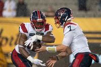 Montreal Alouettes quarterback Cody Fajardo (7) hands off to running back William Stanback (31) during second half CFL football game action against the Hamilton Tiger Cats in Hamilton, Ont. on Friday, June 23, 2023. THE CANADIAN PRESS/Peter Power