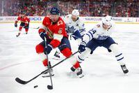 SUNRISE, FLORIDA - OCTOBER 19: Carter Verhaeghe #23 of the Florida Panthers and David Kampf #64 of the Toronto Maple Leafs battle for the puck during the third period of the game at Amerant Bank Arena on October 19, 2023 in Sunrise, Florida. (Photo by Megan Briggs/Getty Images)
