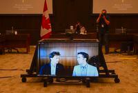 Marc Kielburger, screen left, and Craig Kielburger, screen right, appear as witnesses via videoconference during a House of Commons finance committee in the Wellington Building in Ottawa on Tuesday, July 28, 2020. The committee is looking into Government Spending, WE Charity and the Canada Student Service Grant. THE CANADIAN PRESS/Sean Kilpatrick
