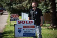 Dallas Harty, a real estate agent in Lethbridge, Alberta poses for a photo outside a home for sale Friday, July 15, 2022.