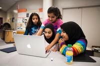 Rayaan Jaffer, 11, middle, helps other participants during a two-day workshop hosted by Hackergal, which aims to foster interest in coding in girls aged 11-14, in Richmond, B.C. on Oct. 20, 2018.