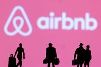 FILE PHOTO: Figurines are seen in front of the Airbnb logo in this illustration taken February 27, 2022. REUTERS/Dado Ruvic/Illustration/File Photo