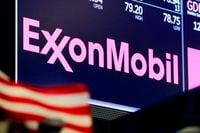 FILE - In this April 23, 2018, file photo, the logo for ExxonMobil appears above a trading post on the floor of the New York Stock Exchange.  With all of the challenges of 2020, ExxonMobil focused on clamping down on expenses and managed to bring its full-year spending down nearly $10 billion from the year before.  (AP Photo/Richard Drew, File)