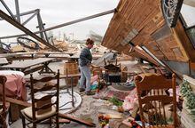 Kimber Hendrickson owner of the Scissortail Silos event centre surveys debris of her venue destroyed during overnight tornadoes in Cole, Oklahoma, U.S., April 20, 2023.  REUTERS/Nick Oxford