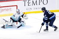 Feb 14, 2023; Winnipeg, Manitoba, CAN; Winnipeg Jets left wing Pierre-Luc Dubois (80) scores on Seattle Kraken goaltender Philipp Grubauer (31) in the shoot out at Canada Life Centre. Mandatory Credit: James Carey Lauder-USA TODAY Sports