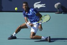 Felix Auger Aliassime, of Canada, returns a volley against Thiago Monteiro, of Brazil, in the first set of a match at the Miami Open tennis tournament, Saturday, March 25, 2023, in Miami Gardens, Fla. (AP Photo/Jim Rassol)