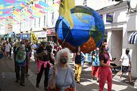 Extinction Rebellion environmental activists and supporters protest in the streets of Falmouth, Cornwall during the G7 summit on June 12, 2021. (Photo by Oli SCARFF / AFP) (Photo by OLI SCARFF/AFP via Getty Images)
