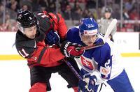 Canada's Dylan Guenther and Slovakia's Peter Repcik battle for position during first period IIHF World Junior Hockey Championship pre-tournament hockey action in Moncton, N.B., on Wednesday, Dec. 21, 2022. THE CANADIAN PRESS/Ron Ward