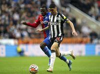 Crystal Palace's Tyrick Mitchell, left, and Newcastle United's Miguel Almiron battle for the ball during the English Premier League soccer match between Newcastle United and Crystal Palace at St James' Park, Newcastle upon Tyne, England, Saturday Oct. 21, 2023. (Owen Humphreys/PA via AP)