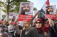 Tunisian women hold up saws and signs showing pictures of Saudi Crown Prince Mohammed bin Salman with a caption below reading in Arabic 'no welcome, Tunisians against the visit of the Saudi Crown Prince to Tunisia,' during an anti-Saudi Crown Prince protest in Habib Bourguiba Avenue in the capital Tunis on Nov. 27, 2018.