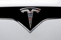FILE PHOTO: The Tesla logo is seen on a car at Tesla Motors' new showroom in Manhattan's Meatpacking District in New York City, U.S., December 14, 2017. REUTERS/Brendan McDermid/