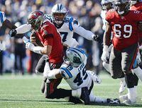 Tampa Bay Buccaneers quarterback Tom Brady (12) is sacked by Carolina Panthers linebacker Frankie Luvu (49) and teammate defensive end Yetur Gross-Matos (97) during the second half of an NFL football game Sunday, Oct. 23, 2022, in Charlotte, N.C. (AP Photo/Rusty Jones)