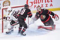 Feb 17, 2023; Ottawa, Ontario, CAN;  Chicago Blackhawks center Andreas Athanasiou scores against Ottawa Senators goalie Mas Sogaard (40) in overtime at the Canadian Tire Centre. Mandatory Credit: Marc DesRosiers-USA TODAY Sports