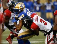 Winnipeg Blue Bombers' Rasheed Bailey (88) gets hit by Ottawa Redblacks' Patrick Levels (3) during the first half of CFL action in Winnipeg, Friday, June 10, 2022. THE CANADIAN PRESS/John Woods