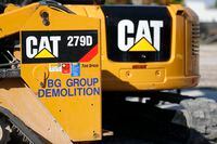 FILE - This May 8, 2019 photo shows a Caterpillar 279D Compact Track Loader, left, and 308E2 CR Mini Hydraulic Excavator, right, rear, at a demolition site in Fort Lauderdale, Fla. Caterpillar Inc. reports quarterly financial results before the market open, Thursday, Oct. 27, 2022.(AP Photo/Wilfredo Lee, File)