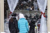 Children look into a store in the village at Blue Mountain Ski Resort in The Blue Mountains, Ont., on the first day of a provincial lockdown amid a 12-day trend of over 2,000 daily COVID-19 cases, Saturday, Dec. 26, 2020. THE CANADIAN PRESS/Cole Burston