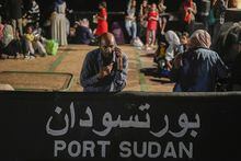 A Sudanese evacuee waits at Port Sudan before boarding a Saudi military ship to Jeddah port, on May 3, 2023. A doctor trying to co-ordinate basic medical services after Sudan's rapid descent into chaos says the government and militias are hampering lifesaving aid and leaving children dying, as Canada crafts its response to the crisis. THE CANADIAN PRESS/AP/Amr Nabil